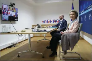  ?? (AP/Olivier Hoslet) ?? European Commission President Ursula von der Leyen (right) and European Council President Charles Michel, in Brussels, take part in Friday’s virtual G-7 meeting.