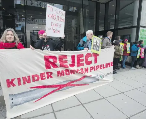  ?? JONATHAN HAYWARD/THE CANADIAN PRESS ?? Shares of Kinder Morgan, a target of anti-pipeline activists, had a rough ride Tuesday as they began trading on the TSX. Investors were deterred by political uncertaint­y in B.C. as well as the company’s plan to use IPO proceeds to pay down its U.S. debt.