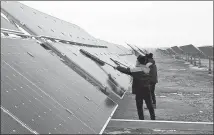  ?? PROVIDED TO CHINA DAILY ?? Workers clean photovolta­ic panels in Dalad Banner, Inner Mongolia autonomous region, on Monday.