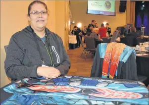  ?? CHRIS SHANNON/CAPE BRETON POST ?? Loretta Gould, a painter who has used her art as inspiratio­n for her clothing line, displays some of the clothing available on her website. Gould was one of four women who participat­ed in a panel discussion on exporting to markets outside Nova Scotia...