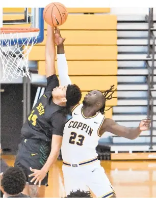  ?? AMY DAVIS/THE BALTIMORE SUN ?? Norfolk State’s Devante Carter, left, drives past Coppin State’s Yuat Alok during a Jan 24 game. Carter and the Spartans will face North Carolina Central in a MEAC quarterfin­al at 8 p.m. today.