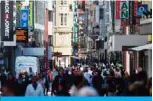  ?? — AFP ?? DORTMUND: People walk past shops on a pedestrian street in Dortmund in Dortmund, western Germany during the novel coronaviru­s COVID-19 pandemic.