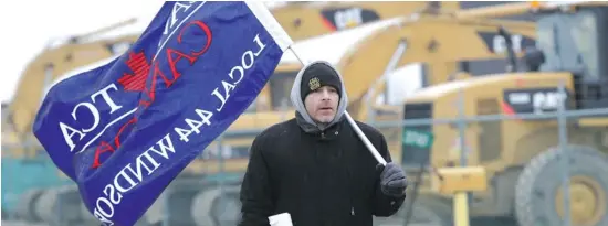  ?? JASON KRYK / THE WINDSOR STAR ?? A CAW member protests outside a Caterpilla­r plant earlier this year. Deloitte’s Bill Currie says unionized labour can be as effective as non-unionized labour when they learn to collaborat­e.