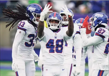  ?? Corey Sipkin / Associated Press ?? The Giants’ Tae Crowder (48) celebrates his intercepti­on during the first half against the Eagles on Sunday.