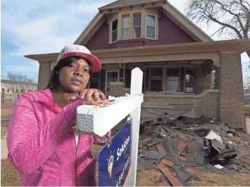  ?? SENTINEL MARK HOFFMAN / MILWAUKEE JOURNAL ?? Destinie Grafton stands outside the 6th St. home she rents from an Elijah Mohammad Rashaed company. She says the notorious landlord tried to pressure her into buying the house. Shingles and debris from a recent repair are piled on the front lawn of the...