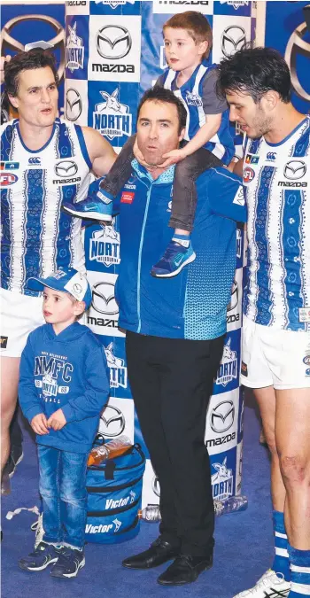  ?? Picture: GETTY ?? Departing coach Brad Scott and his sons join the team circle for the final time after the Kangaroos stunned the Western Bulldogs 18.7 (115) to 13.12 (90) at Marvel Stadium yesterday