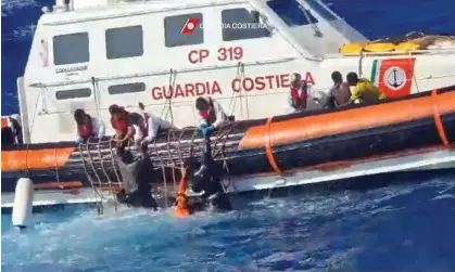  ?? ?? Survivors being helped on to a rescue boat after a separate sinking on Sunday. Photograph: Italian Coastguard/Guardia Costiera/AFP/ Getty