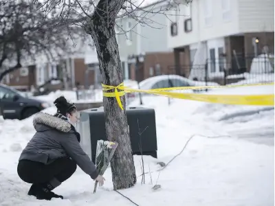  ??  ?? Neighbourh­ood resident Jennifer Fuller places flowers on Friday outside a house in Brampton, Ont., where Riya Rajkumar, 11, was found dead. The girl’s father, who did not live with Riya and her mother, is in hospital in police custody facing charges of first-degree murder.