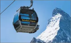  ?? Jean-Christophe Bott / Keystone via AP ?? The “Matterhorn-Express” gondola lift is shown in front of Matterhorn mountain in Zermatt, Switzerlan­d in March. Restrictio­ns to slow the curve of coronaviru­s infections have kept ski lifts closed in Italy, France, Germany and Austria. But skiers are already heading to mountains in Switzerlan­d, drawing an envious gaze from ski industry and local officials in mountain regions elsewhere on the continent who lost most of last season due to the virus.