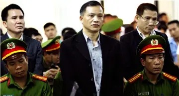  ??  ?? Dai (centre) and other political activists Pham Troi (left) and Naguyen Trung Ton (right) stand in a courtroom during their trial in Hanoi. — AFP photo