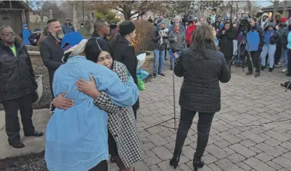  ?? JOHN STARKS/DAILY HERALD ?? Tomika Reed, sister of Cartez Daniels, is embraced by Liz Campbell on Wednesday at a vigil at DuPage Township Center for the victims of Sunday’s shooting.