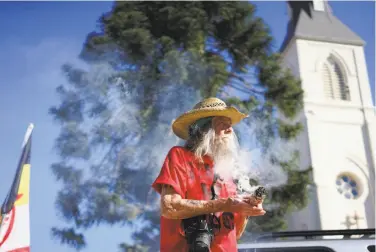  ?? James Tensuan / Special to The Chronicle ?? Autumn Sun burns sage for cleansing at a protest at Holy Cross Church in Santa Cruz. A Walk for the Ancestors will visit every mission in a statement against the canonizati­on of Junipero Serra.