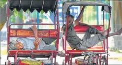  ?? PTI ?? Rickshaw pullers rest under a tree on a hot summer afternoon, in New Delhi.