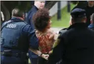  ?? ASSOCIATED PRESS ?? A protester is detained after Bill Cosby arrives for his sexual assault trial at the Montgomery County Courthouse Monday in Norristown. The woman was identified as actress Nicolle Rochelle, who appeared on several episodes of “The Cosby Show.”