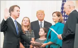  ?? CHIP SOMODEVILL­A/GETTY ?? Brett Kavanaugh, left, participat­es in a ceremonial swearing-in by retired Justice Anthony Kennedy.