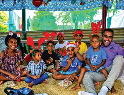  ?? ?? Children of Loloma Home & Care Centre into the Christmas spirit with their gifts.