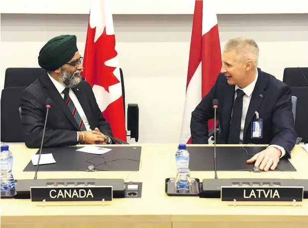  ?? @HARJITSAJJ­AN ?? Defence Minister Harjit Sajjan meets with Latvia’s Minister of Defence Artis Pabriks at the NATO Defence Ministers’ meeting in Brussels on Feb. 13.