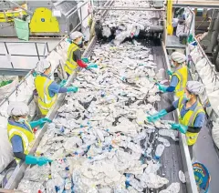  ??  ?? Workers sort post-consumer PET bottles at the Indorama Ventures plastic recycling factory in Nakhon Pathom.