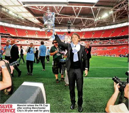  ??  ?? SILVER SERVICE
Mancini raises the FA Cup after ending Manchester City’s 35-year wait for glory