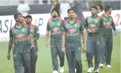  ??  ?? Heartbreak: Bangladesh players are stunned by their last-ball defeat. — AFP Photo