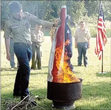  ?? RITA GREENE MCDONALD COUNTY PRESS ?? Boy Scouts of America Troop 95 based in Anderson conducted the Flag Retirement Ceremony at Town Hole in Anderson Saturday by reverently burning tattered and torn American flags.