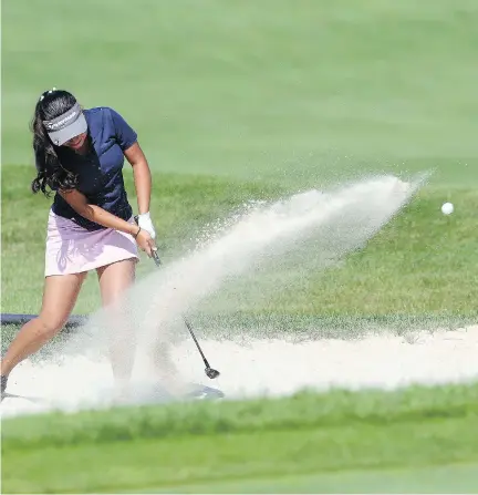  ?? JEAN LEVAC ?? Sukriti Harjai of Niagara Falls shoots out of the sand on the 18th hole during the first round of the Canadian Junior Girls Golf Championsh­ip held at Camelot Golf and Country Club in Ottawa on Tuesday. The 6,037-yard layout saw only three players shoot...