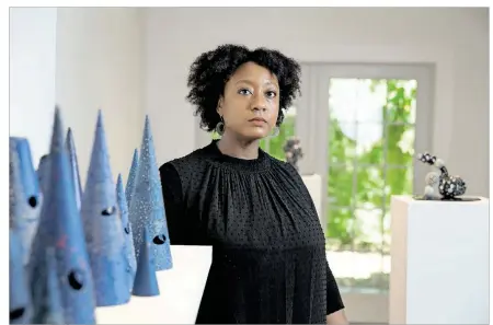  ?? DAVE CREANEY/AMERICAN-STATESMAN ?? For her first solo exhibit in Austin since moving to town last year, Tammie Rubin debuts a new series of intricate, intimate and evocative porcelain sculptures.