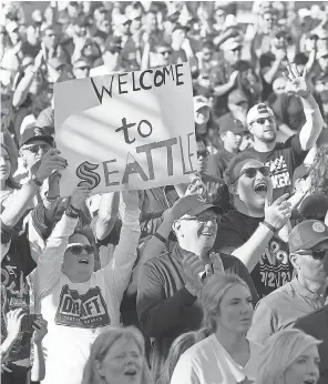  ?? KAREN DUCEY/ GETTY IMAGES ?? Fans celebrate at the Seattle Kraken expansion draft at Gas Works Park.