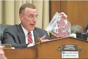  ??  ?? Rep. Tim Murphy, R-Pa., chairman of the House Energy and Commerce Subcommitt­ee, holds up a Ziploc bag as an example of how pathogenic agents were handled at the CDC in July 2014. H. DARR BEISER/USA TODAY