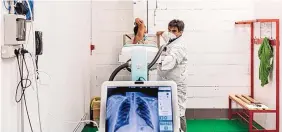  ?? ALBERTO BERNASCONI/WASHINGTON POST ?? A patient gets an X-ray at a Bergamo, Italy, convention center that was converted for COVID-19 patients in the spring and is now used for follow-up care.