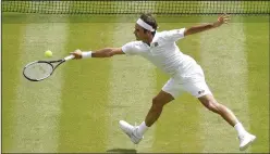  ?? STEPHEN CHUNG/TRIBUNE NEWS SERVICE ?? Roger Federer of Switzerlan­d hits a return during a quarterfin­al match against Adrian Mannarino of France at the Wimbledon Championsh­ips on Monday.