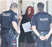  ?? REUTERS ?? Police officers speak to neighbours after four children and two adults were found dead inside a nearby home in the Ottawa suburb of Barrhaven, Ontario, on Thursday.