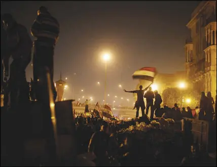  ?? ED OU / THE NEW YORK TIMES FILE (2011) ?? Demonstrat­ors celebrate the toppling of Egyptian President Hosni Mubarak from power Feb. 11, 2011, in Cairo, after 18 days of protests against his government. The collisions between the old order and popular uprisings across the Middle East that began in 2011 and became known as the Arab Spring have left much of the region in smoldering ruins, but also whet an appetite for change.