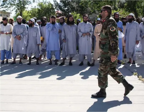  ?? Stefanie Glinski for The National ?? Taliban prisoners wait for their release at a government prison north of Kabul. Nine hundred were freed across Afghanista­n on Tuesday, the last day of Eid Al Fitr and the three-day ceasefire