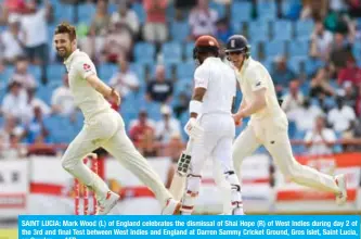  ?? — AFP ?? SAINT LUCIA: Mark Wood (L) of England celebrates the dismissal of Shai Hope (R) of West Indies during day 2 of the 3rd and final Test between West Indies and England at Darren Sammy Cricket Ground, Gros Islet, Saint Lucia, on Sunday.