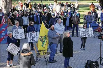  ?? John Hanna / Associated Press ?? Several hundred people who oppose President Joe Biden’s COVID-19 vaccine mandates rally Saturday outside the Kansas Statehouse in Topeka, Kan.