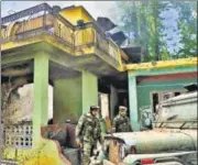  ?? PTI ?? Army personnel stand outside a house that was damaged during an encounter between militants and security forces at Soimoh village in Pulwama district of south Kashmir on Saturday.