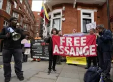  ?? Frank Augstein/Associated Press ?? Protesters stand in front of the Ecuadorian Embassy in London on Thursday, where WikiLeaks founder Julian Assange was arrested five years ago.