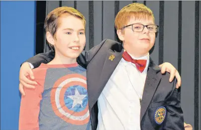  ?? DAVE STEWART/THE GUARDIAN ?? Jack MacKinnon, left, a Grade 6 student at Prince Street School in Charlottet­own, is shown with Easter Seals Ambassador Brayden White. Jack presented Brayden with a cheque for $500 Wednesday as the Easter Seals school tour kicked off. The tour...