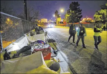  ?? Chase Stevens Las Vegas Review-Journal file ?? Volunteers find homeless people along Veterans Memorial Drive in January during the Southern Nevada Homeless Census. Next year’s count will last three days.