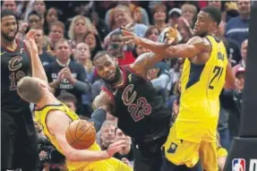  ?? Gregory Shamus, Getty Images ?? LeBron James (23) of the Cavaliers battles for the ball against the Pacers’ Thaddeus Young (21) during Game 7 of the Eastern Conference Quarterfin­als on Sunday.