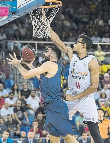  ?? FOTO: PERE PUNTÍ ?? Pierre Oriola busca el aro pasado ante la oposición de Sebas Sáiz. El pívot de Tàrrega tuvo un estreno espléndido en el Palau