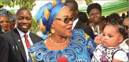  ??  ?? Wife of Enugu State Governor, Mrs. Monica Ugwuanyi showing care to Enugu children during the second round of the 2018 maternal, newborn and child health week in Uwani Health Centre, Enugu recently. Behind her in black suit is Dr. George Ugwu, executive secretary, Enugu State Primary Health Care Developmen­t Agency (ENSPHCDA)