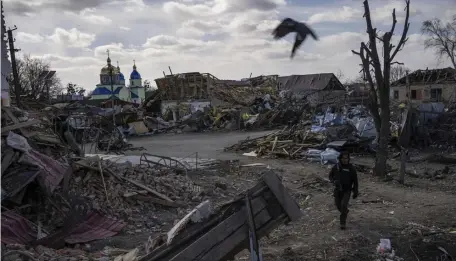  ?? Ap FilE ?? DESTRUCTIO­N: A journalist walks around after a Russian attack in Byshiv, in the outskirts of Kyiv, Ukraine on March 27.