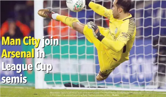  ?? — Reuters ?? Manchester City’s Claudio Bravo saves a kick from Leicester City’s Riyad Mahrez during the penalty shoot-out in the League Cup quarterfin­al at King Power Stadium, Leicester, Britain.