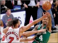  ?? AP/CHARLES REX ARBOGAST ?? Isaiah Thomas (right) of the Boston Celtics passes under pressure from Michael Carter-Williams (7) and Robin Lopez of the Chicago Bulls during Friday’s NBA Eastern Conference playoff game. Boston won 104-87 and trails 2-1 in the series.