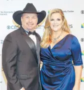  ?? PAUL MORIGI/GETTY ?? Garth Brooks and Trisha Yearwood, who has published her fourth cookbook, are seen on May 21.