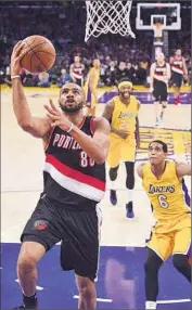  ?? Mark J. Terrill Associated Press ?? PORTLAND’S Nicolas Batum goes in for an easy basket as Jordan Clarkson trails the play.