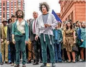  ?? NICO TAVERNISE/NETFLIX ?? Oscar nominee Sacha Baron Cohen (front, right) leads the march through Chicago’s city streets in “The Trial of the Chicago 7.”