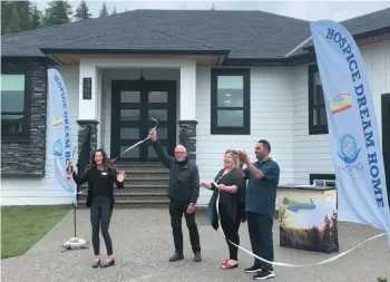  ??  ?? CITIZEN PHOTO BY ARTHUR WILLIAMS Sandra Klimm of the Prince George Hospice Society, John Brink of Brink Properties Ltd., hospice executive director Donna Flood and Ruby Grewel of North Nechako Homes cut the ribbon officially opening the 2020 Prince George Dream Home Lottery on Tuesday.